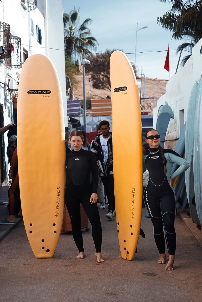 Students meeting at the surf school with their boards