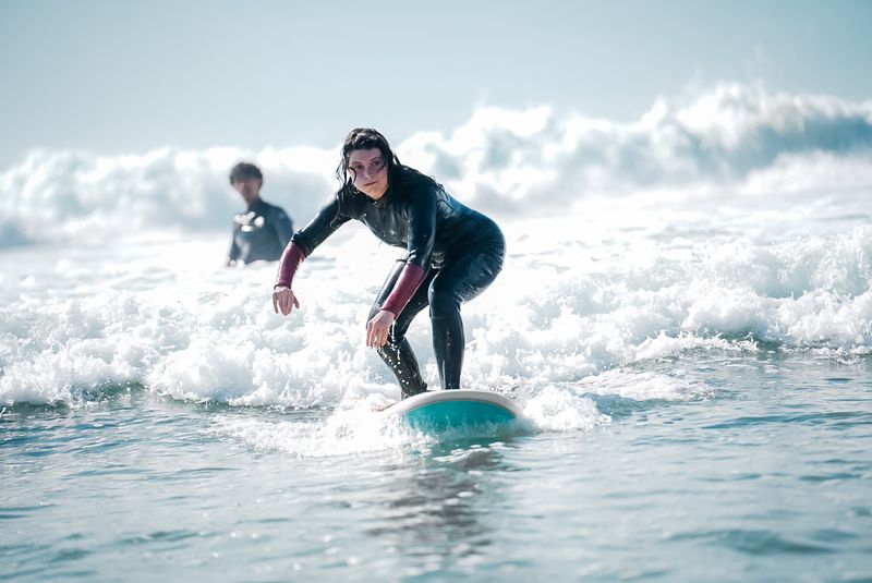 Improving surfer riding a wave during a coaching session in Taghazout, Morocco