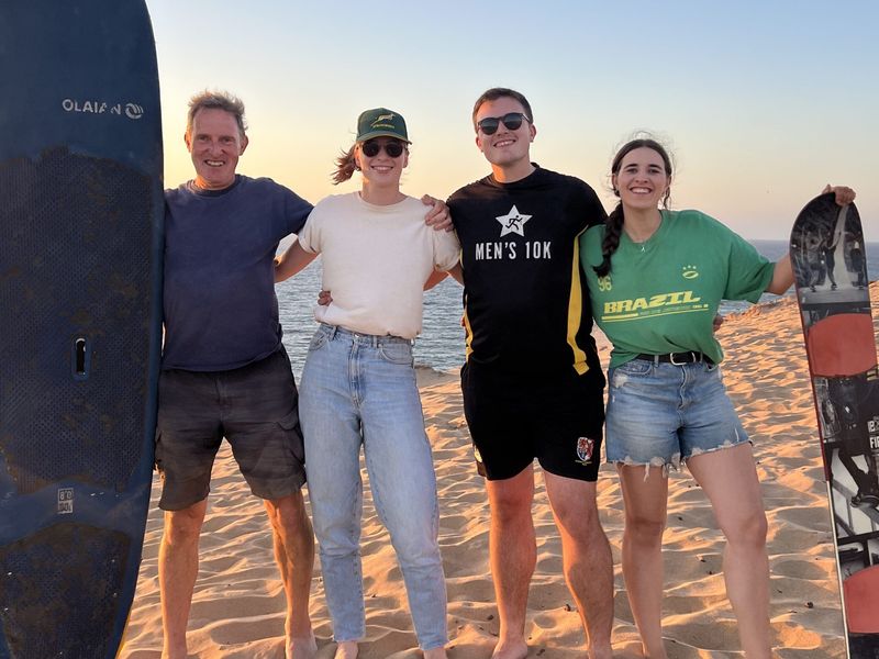 Sandboarding down the golden Timlaline dunes near Taghazout, Morocco